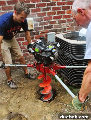 Man visibly exerting effort with the auger