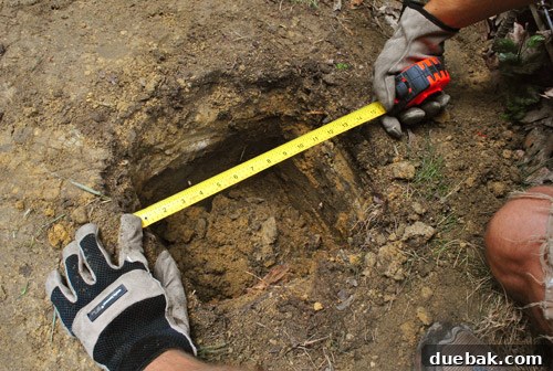 Measuring post hole width with a tape measure