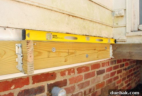 Installing joist hangers on the ledger board