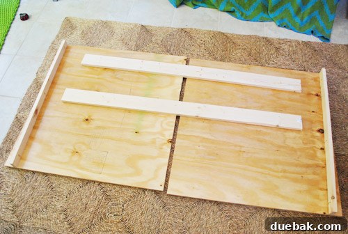All cut wood pieces laid out on the floor, showing the headboard assembly plan