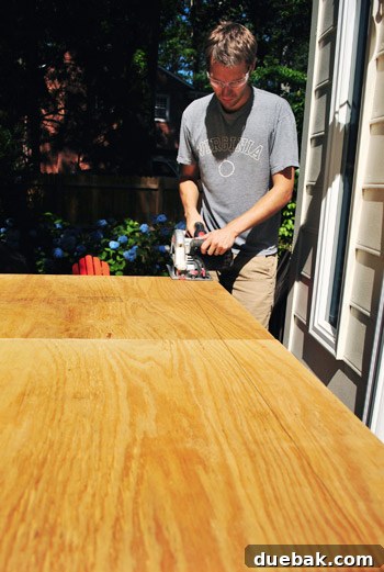 A circular saw being used to cut down the top edge of the assembled headboard frame