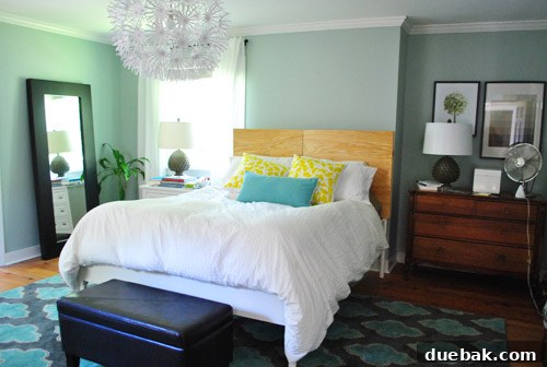 The headboard frame in place behind the bed after being cut down to the ideal height