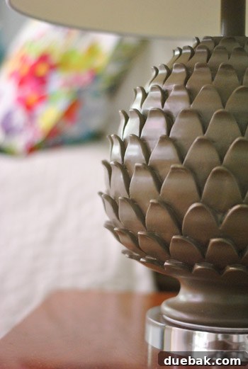 The Evolving Sanctuary 20 Master bedroom with DIY headboard and pineapple-based lamps, showcasing personal touches