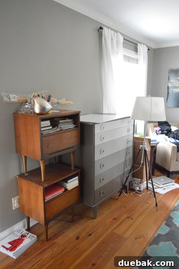 Why Your Bedroom Needs A TV Now 4 Before photo of a cluttered bedroom wall, showcasing the need for organization and transformation.