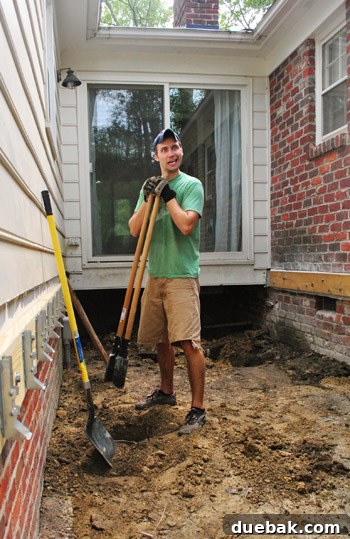 A candid shot of a man making a funny, tired but satisfied face during the intense deck construction work.