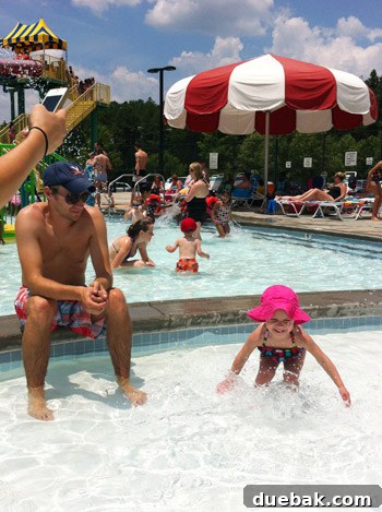 Couple smiling happily at a swimming pool
