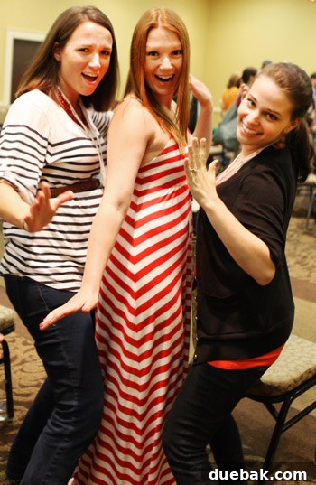 Three women strike a playful pose, similar to an 8th-grade dance