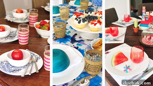 A glimpse of Clara nearby, enjoying strawberries while the Fourth of July table settings are being arranged.