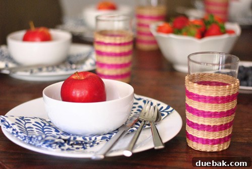 Overhead view of a casual Fourth of July table setting with fresh fruit and everyday dishware.