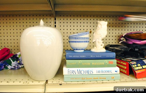 Ceramic urn, stack of books, rice bowls, and a ceramic owl for a vignette