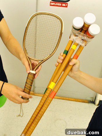 Old tennis racket and colorful croquet mallets for wall art