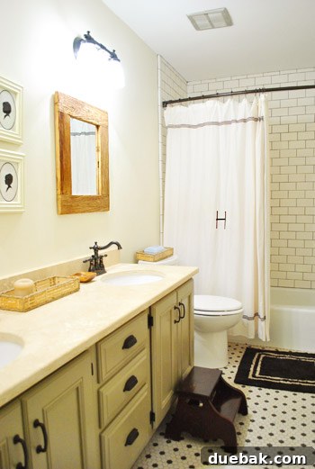 Vibrant Home Breakthrough 17 Hall bathroom with white subway tile, gray grout, and a painted vanity.