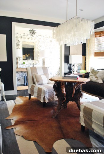 Vibrant Home Breakthrough 5 Dramatic sitting room with black walls, layered textures, and a West Elm chandelier.