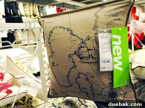 Benzy Land map pillow, ideal for an adventure-themed den with navy and wood decor