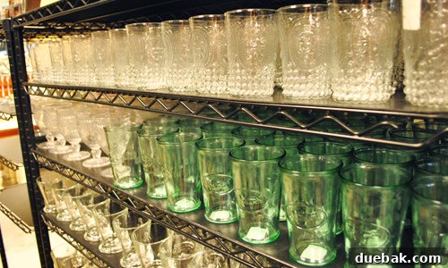 A selection of pretty glassware, including cups on the top shelf.