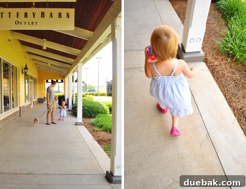 Husband with child and dog outside the store, patiently waiting.
