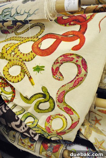 Close-up of a vibrant yellow snake fabric with pink spots.