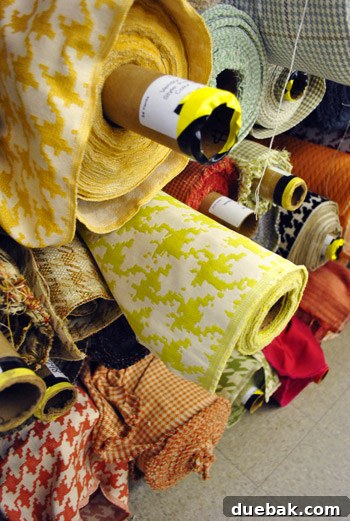 Two rolls of pixelated-looking fabric, one with grey and yellow tones.
