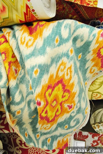 Close-up of the Ubud ikat fabric in orange, pink, yellow, and blue.