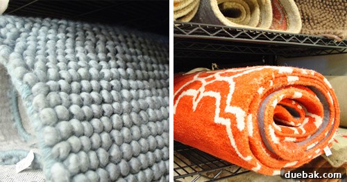 Two rugs, one silvery blue and one bright orange Moroccan style.