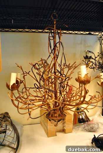 A delicate, bird's nest-like light fixture in antique bronze.