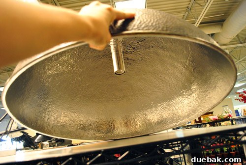A large, hammered silver light fixture, about three feet wide.