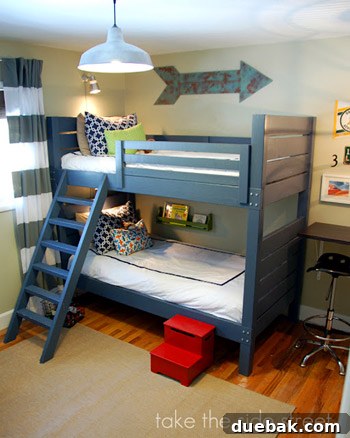 Dreamy Blue Bunk Room Makeover for a Young Boy 2 Thoughtful boys room decor with a plush rug and vibrant wall art.