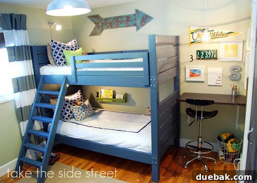Dreamy Blue Bunk Room Makeover for a Young Boy 7 Corner desk space in a boys' room, perfectly integrated next to a bed.
