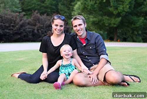 Smiling family portrait with parents and a baby