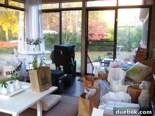 Sunroom filled with photography props and equipment during a magazine photoshoot, capturing the beautiful chaos of the styling process.