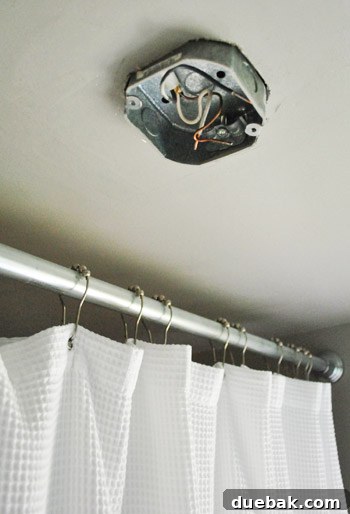 Old electrical box hanging loose after screws are removed