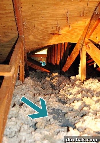 Navigating the cramped and hot attic space to reach the light fixture
