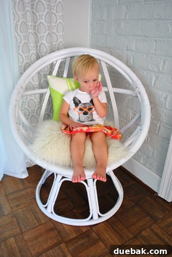 Clara, the author's daughter, sitting in the white egg chair.