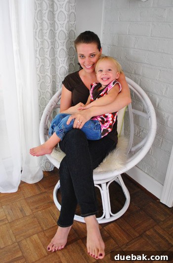 The author and her daughter Clara snuggling together in the newly painted white egg chair, demonstrating its adult scale and coziness.