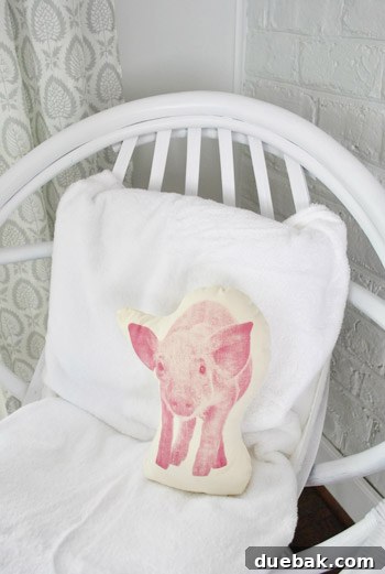 Close-up of the egg chair with a pig pillow, highlighting its playful styling.