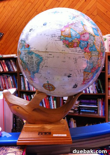Secondhand Adventures 22 White globe held by a whale figurine, purchased for $19