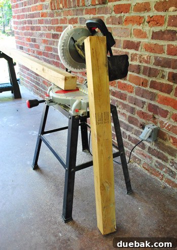 Long 4x4 lumber post being measured for cutting