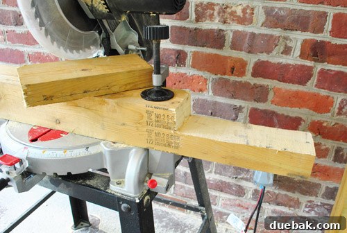Deck post with a freshly cut notch, resting on a miter saw