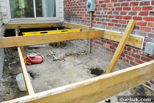 Temporary joist placed across the middle of the deck frame to guide girder height