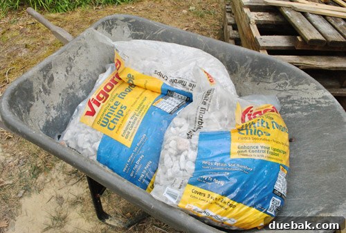 Bags of gravel ready to be spread over the weed block under the deck.