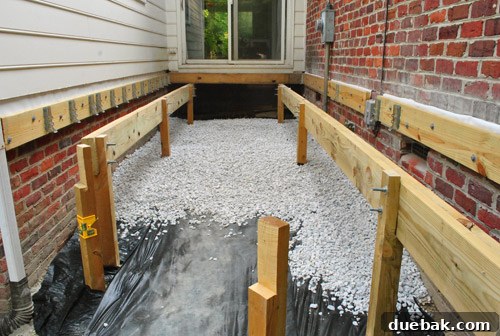 The under-deck area nearly fully covered with a layer of gravel.