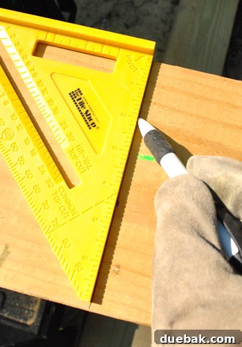Measuring and marking a lumber board for cutting into deck joists.
