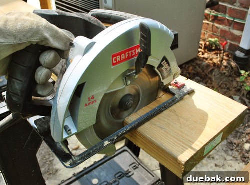 Using a circular saw to cut a lumber board for deck joists.