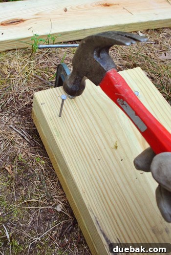 Nailing two lumber boards together to form a double-thick girder.