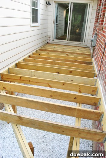 A wide view of the completed deck framing, showcasing the structure.