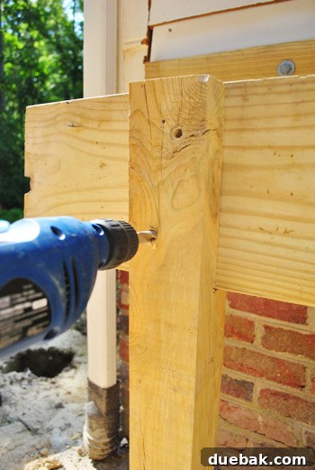 Drilling pilot holes through the double-thick girder and support post.
