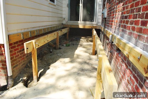 Completed double-thick girders resting on notched posts, showcasing bolted connections.