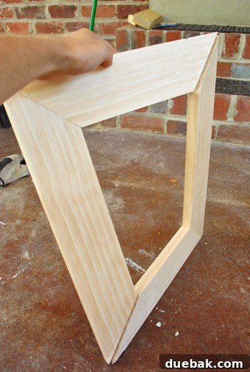 Transform Scrap Wood Into Gorgeous Picture Frames 15 Inspecting a slightly wonky frame corner