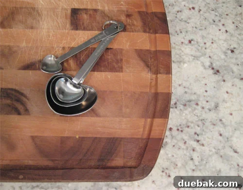 Our Newlywed Wishlist 5 Heart Shaped Measuring Spoons On Cutting Board