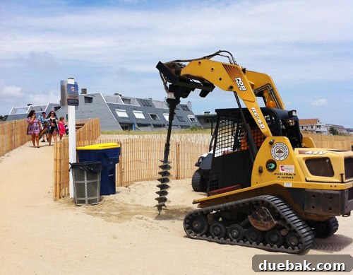 Bethany Beach Bliss: A Delaware Getaway 13 A utility vehicle with a post-hole digger attachment on a beach.